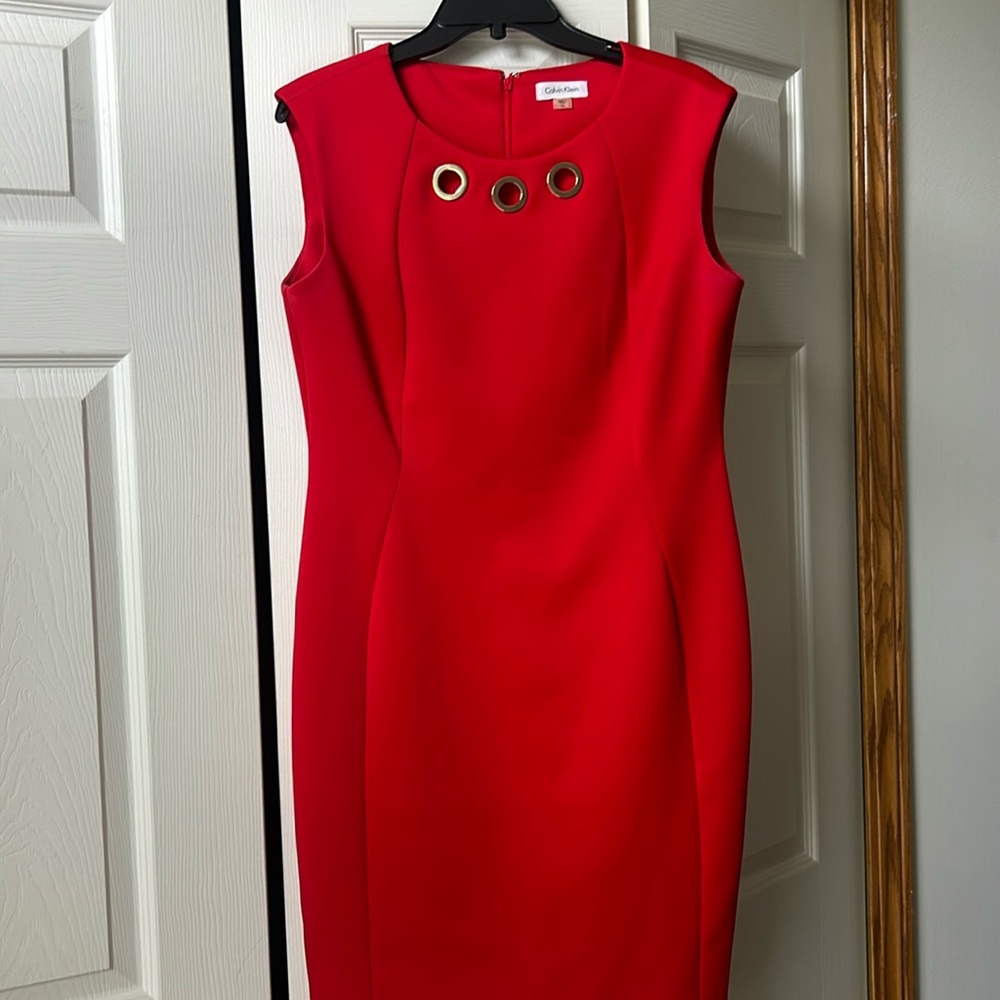 Classic red Calvin Klein dress with gold grommets.